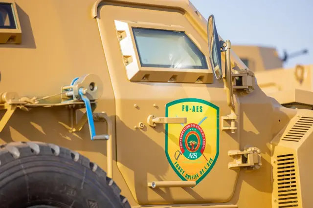 A military vehicle with a 'FU-AES' sign on it