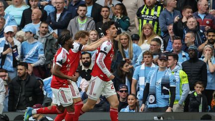 Arsenal players Noni Madueke, Martin Odegaard and Kai Havertz celebrate a goal against Manchester City