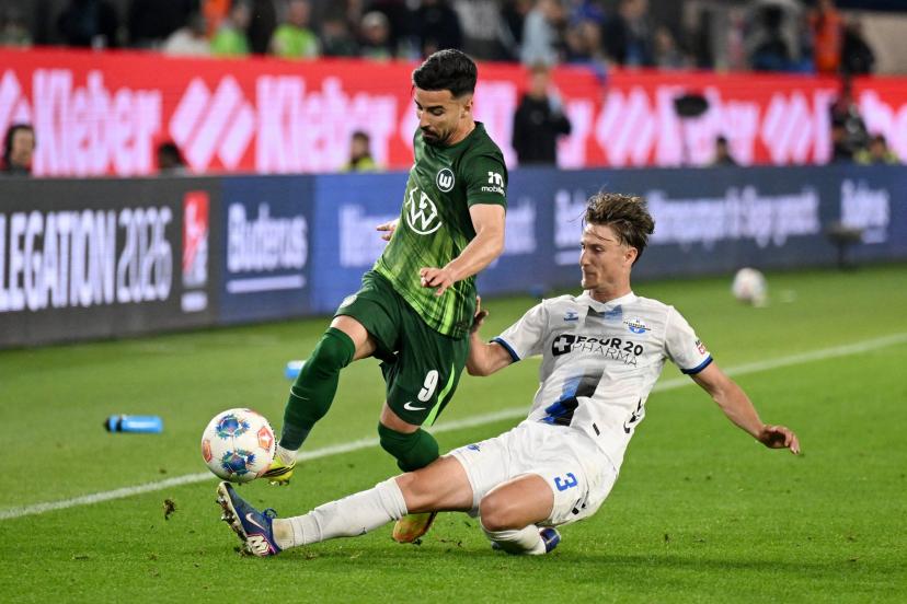 Wolfsburg players in action against Paderborn during the Bundesliga relegation playoff