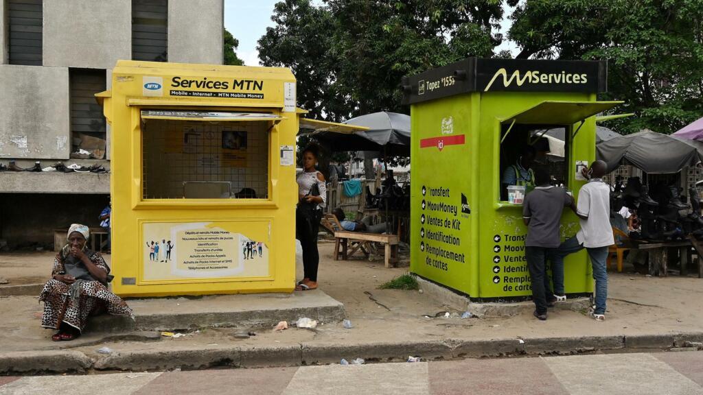Mobile money transfer agencies in a neighbourhood of Abidjan, Côte d'Ivoire.