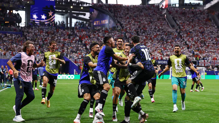 Soccer players celebrate a goal