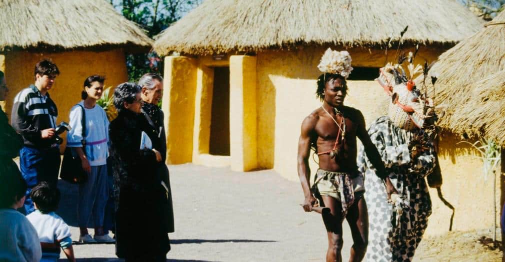 Photograph of protestors holding signs against the Village de Bamboula