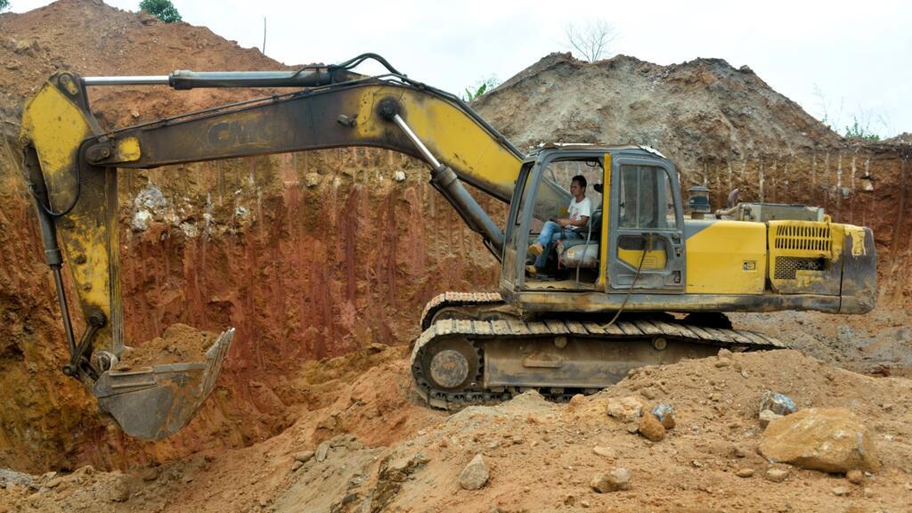 A Chinese employee operates a bulldozer at a mining site near Betare Oya, Cameroon, on April 4, 2018.