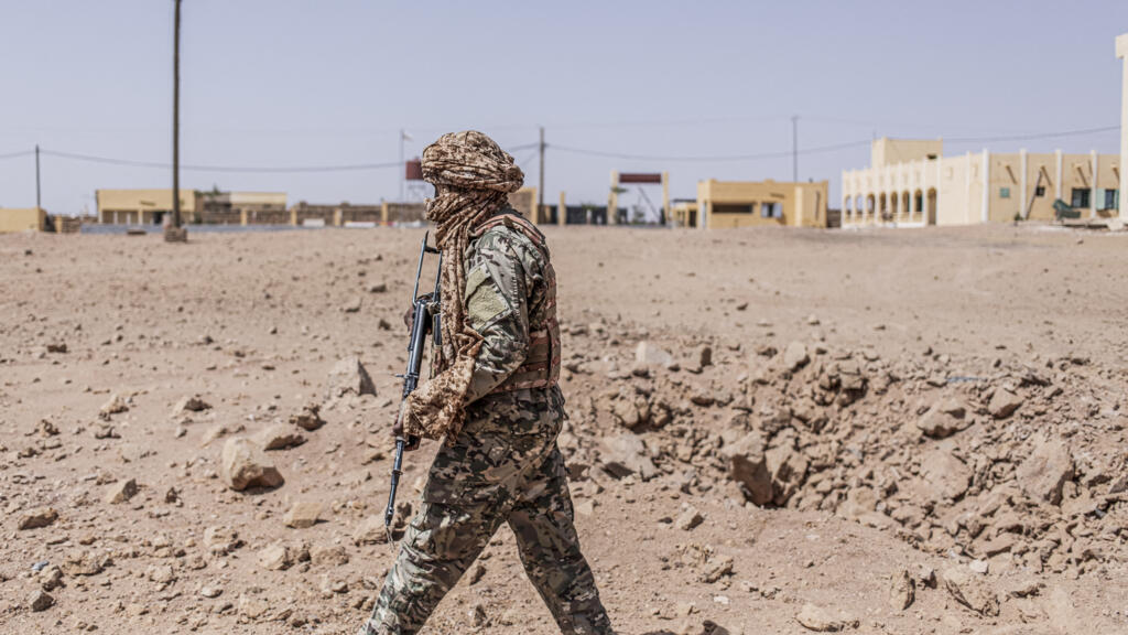 A soldier from the National Liberation Front of Azawad inspects a bomb crater from a Malian air force strike in Kidal, May 14, 2026.
