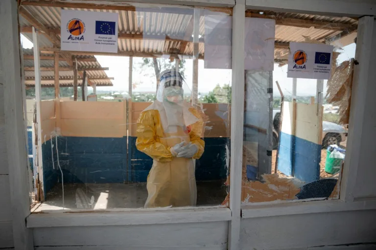 Health workers in protective gear treating Ebola patients in the Democratic Republic of the Congo