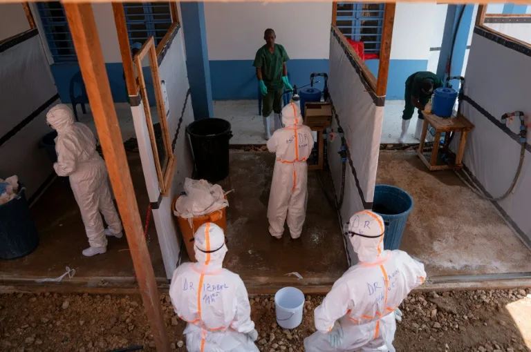 Healthcare workers in protective gear treating Ebola patients