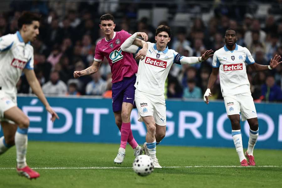 Rasmus Nicolaisen challenges Leonardo Balerdi during the Coupe de France quarter-final between Marseille and Toulouse at the Velodrome on March 4, 2026